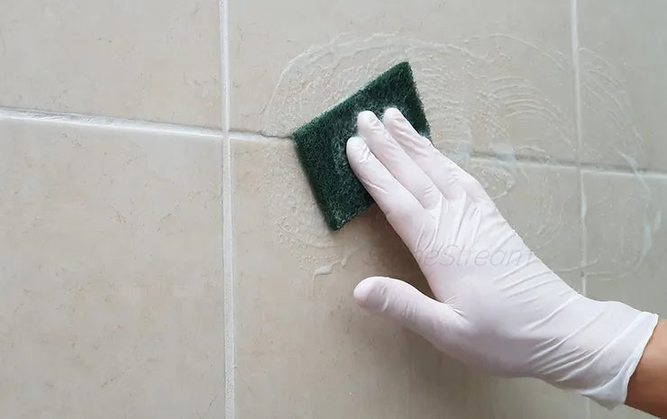 Cleaning shower grout with brush and solution for mold-free tile joints